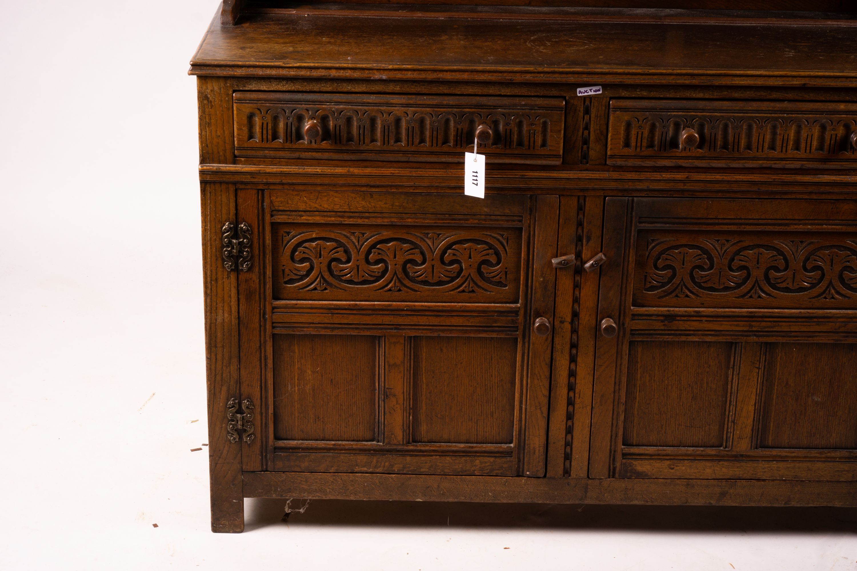 An 18th century style carved oak dresser, width 124cm, depth 46cm, height 175cm